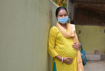 Indian rural pregnant women wearing medical masks due to illness, dizziness. Healthy pregnancy...