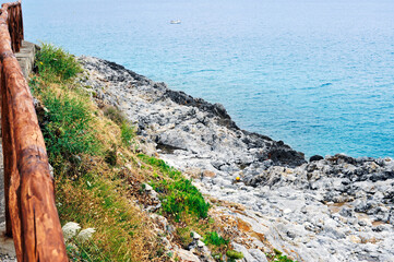 Path with picket fence along a cliff. Littoral.
