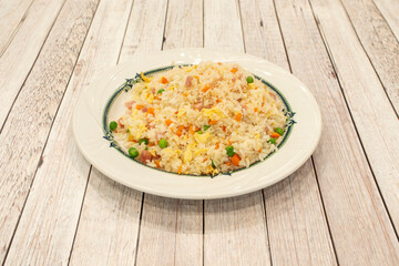 Three delights rice plate made with Chinese restaurant recipe, with green beans, omelet, carrot and ham