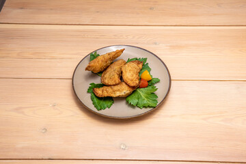 Spanish tapas of fried dumplings stuffed with roast chicken with cherry tomatoes