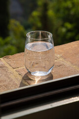 Glass of water for the refreshment on the windowsill on a hot summer day in Italy. Toscana, Italia