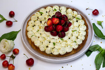 Cherry pie with pistachio cream, basil, and whipped cream.