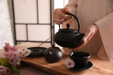 Master conducting traditional tea ceremony at table, closeup