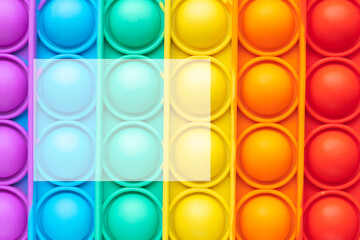 Close-up of a pop-it toy. Colorful background and copy space transparent