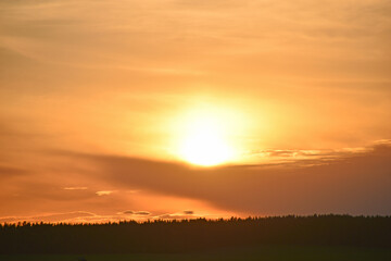 Sunset horizon with sun and clouds in the evening