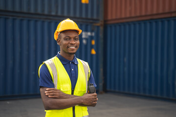 Happy African worker smailing, standing in the container workplace and crossed arms with feeling...
