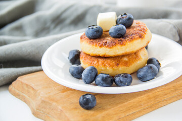 A healthy breakfast of pancakes, berries, butter, and honey. Creative atmospheric decoration