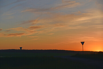 Fototapeta na wymiar Rural field on the background of the setting sun