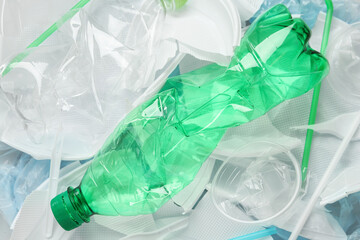 Pile of different plastic items as background, top view