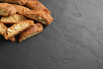 Traditional Italian almond biscuits (Cantucci) on grey table, flat lay. Space for text
