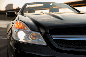 Fototapeta na wymiar Luxury black convertible car outdoors, closeup view