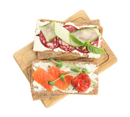 Fresh rye crispbreads with different toppings on white background, top view