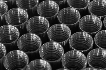 Background from many metal pipes packed in rows. Lots of internally threaded pipes. Plumbing...