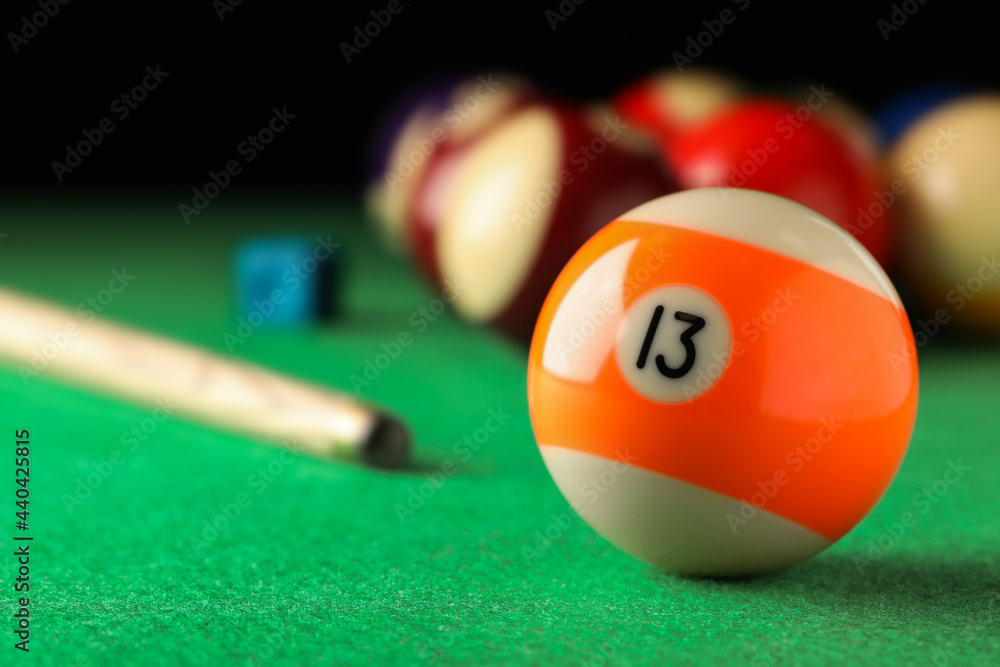 Sticker Billiard ball with number 13 on green table, closeup. Space for text