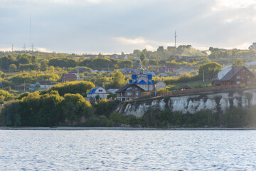 The small village on the banks of the Volga River covered with fog in the middle Volga region in...