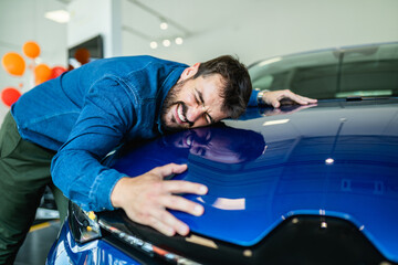 Excited man happy because of buying a new car.