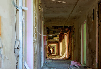 corridor of an old abandoned building, everything is broken, everywhere there is dirt and ruin