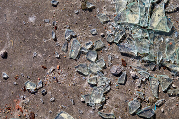 broken glass lies on the concrete floor, close-up