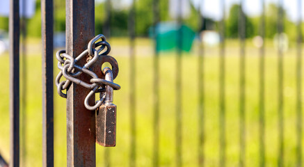 metal chain and lock hang on the metal door