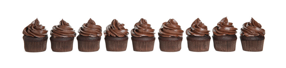 Delicious chocolate cupcakes with cream on white background