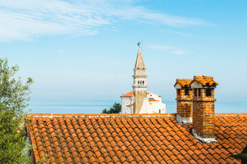 Sunny summer view of St. George's Parish Church in Piran town. Beautiful cityscape of Slovenia,...