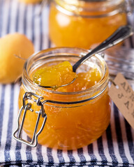 Homemade Organic Jam in Glass Jasr and Ripe Apricots on Linen Napkin Close Up