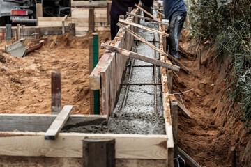 Timber formwork with metal reinforcement for pouring concrete and creating a solid foundation for a...