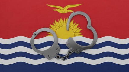 A half opened steel handcuff in center on top of the national flag of Kiribati