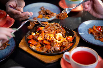 people at the table are eating oriental food