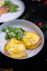 eggs benedict delicious breakfast on black background