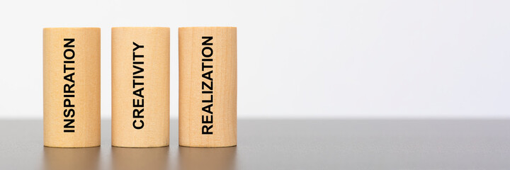 inspiration, creativity and realization written on three pillars
