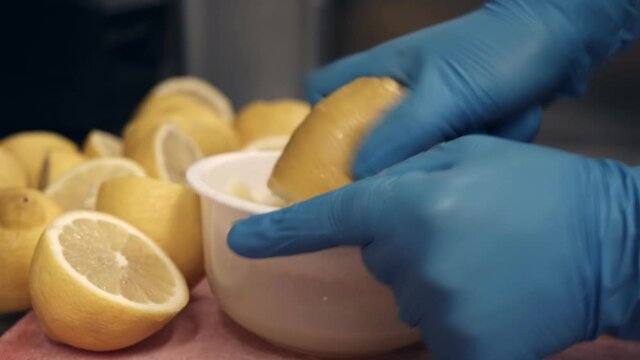 Squeezing lemon juice on a stainless  squeezer 
