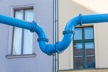 The blue water pipe connects two houses  - 440439809