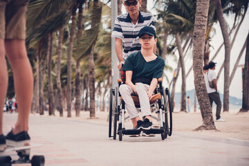Disabled child smile face with activity outdoor on the street in front of the beach, Lifestyle of...