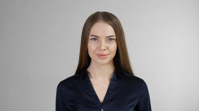 Beautiful woman with long smoth brunette hair looking camera close up