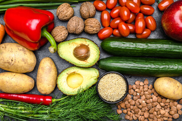 Healthy food background. Healthy vegetarian food. Vegetables and fruits on black stone. Clean vegetarian eating concept.