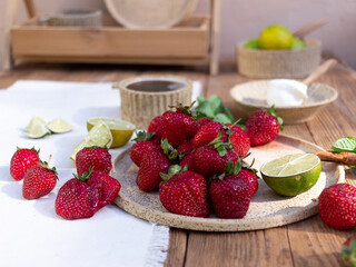 Strawberries on a ceramic plate on a wooden background
