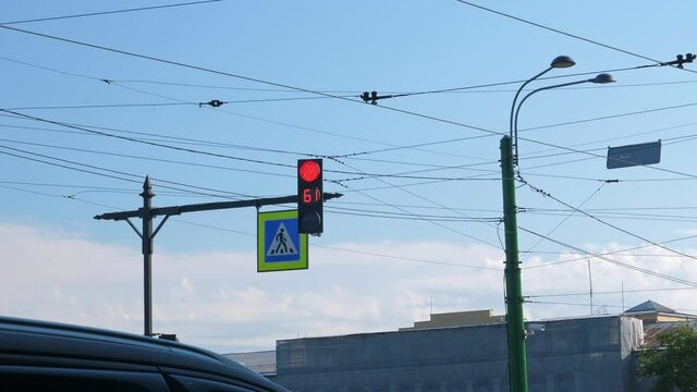 Pedestrian traffic light on street in the city on blue sky background