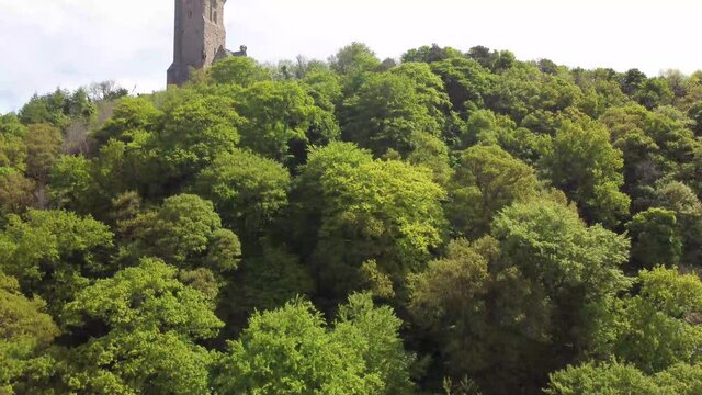 4k drone footage of the National Wallace Monument overlooking the city of Stirling in Scotland, UK