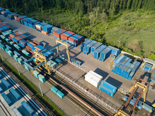 Multicolored freight containers at the railway customs. Aerial drone view.