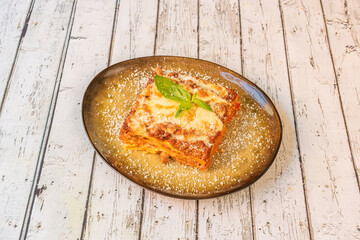 typical Italian lasagna recipe with lots of layers of wheat flour pasta, minced meat stewed with tomato, basil, bechamel and grilled cheese