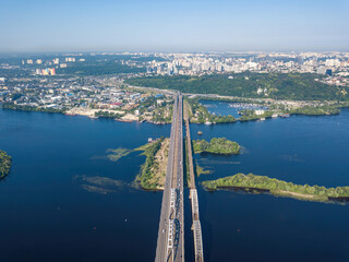 Darnitsky bridge in Kiev in sunny weather. Aerial drone view.