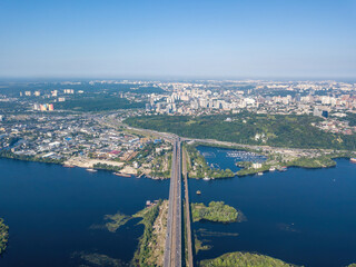Fototapeta premium Darnitsky bridge in Kiev in sunny weather. Aerial drone view.