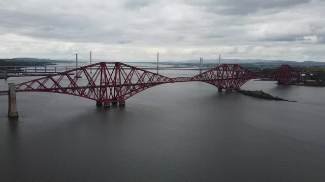 4k drone footage of the Forth Bridges crossing the Firth of Forth at Queensferry, Edinburgh, Scotland