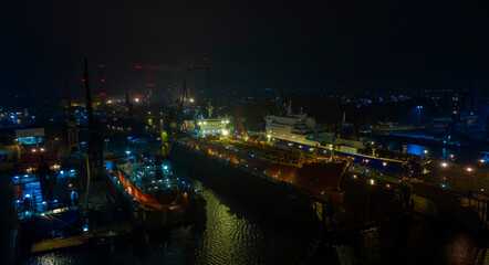 Air night panorama Remontova shipyard  with ships in to dry docks. Poland, Gdansk, drone footage, natural light.
