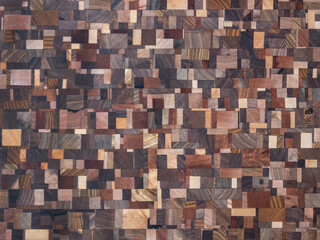 Background. Wooden texture. Beautiful wooden mosaic assembled from wooden pieces of different...