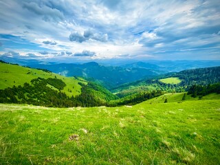 Fototapeta na wymiar Epic landscape with hills and mountains on a peaceful day in Romania