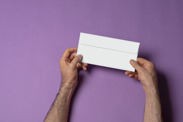 Male holding a letterhead paper envelope