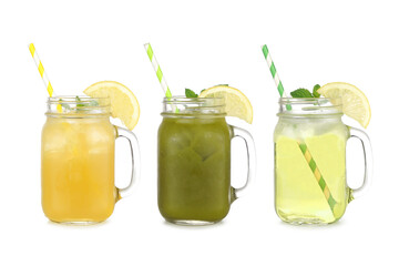 Summer iced green teas in mason jar glasses isolated on a white background. Iced green tea lemonade, iced matcha lemonade and iced green tea. - obrazy, fototapety, plakaty