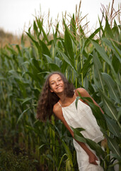 Teen girl in corns field in a summer evening